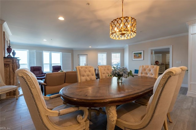 dining room with crown molding, recessed lighting, baseboards, and light wood-style floors