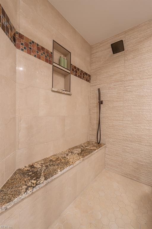 full bath with a tile shower