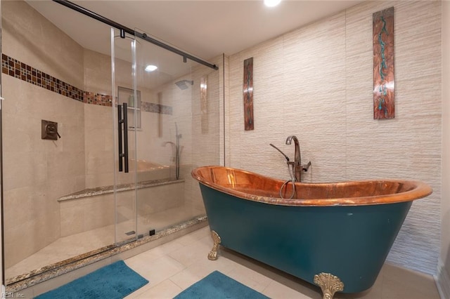 bathroom featuring a stall shower, tile patterned flooring, tile walls, and a freestanding bath