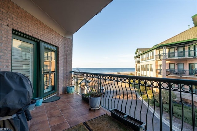 balcony featuring a water view and grilling area