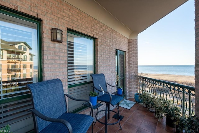 balcony with a water view and a beach view