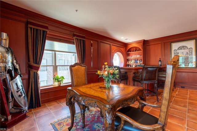 dining room with light tile patterned floors and a dry bar