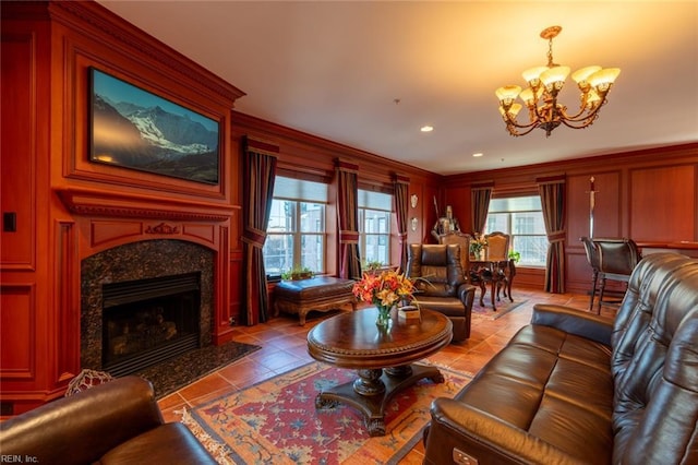 living area featuring a high end fireplace, tile patterned floors, an inviting chandelier, a decorative wall, and recessed lighting