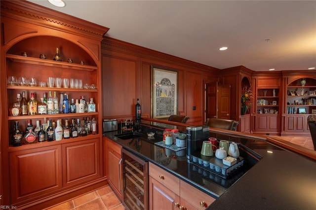 bar featuring light tile patterned floors, built in features, wine cooler, a bar, and a sink