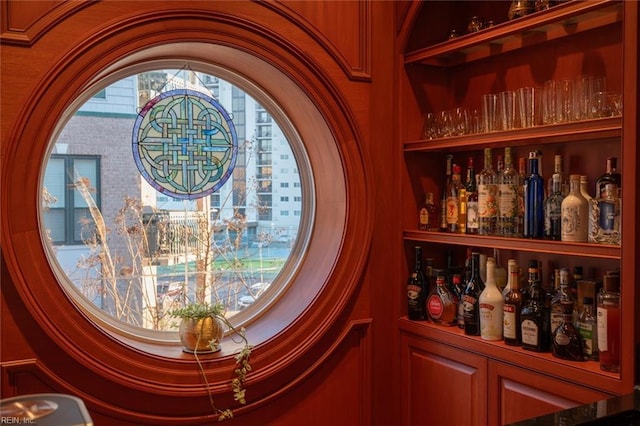 interior details featuring a bar and built in shelves