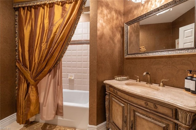 full bathroom featuring shower / tub combo, baseboards, wallpapered walls, and vanity