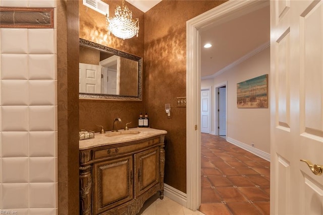 bathroom featuring visible vents, crown molding, baseboards, and tile patterned floors