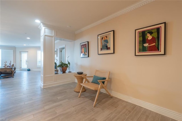 sitting room featuring light wood-style flooring, baseboards, crown molding, and recessed lighting