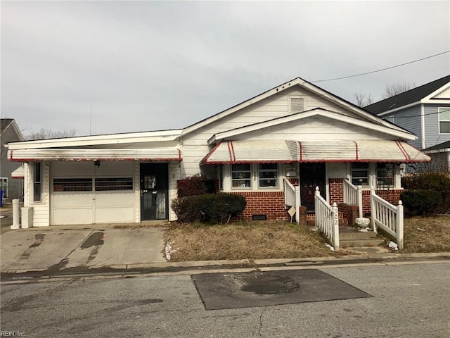 view of front of property featuring concrete driveway, crawl space, and an attached garage