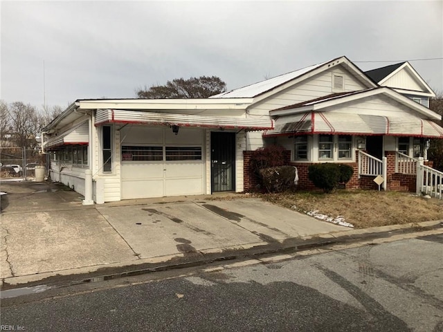 view of front of house featuring concrete driveway, brick siding, and an attached garage