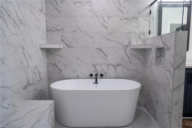 bathroom with a soaking tub and vanity