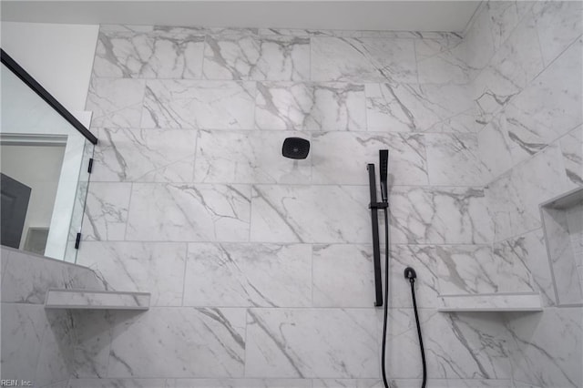 interior details with a tile shower