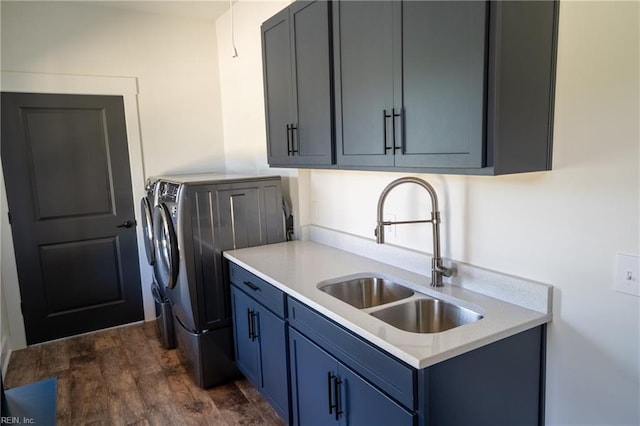 washroom featuring separate washer and dryer, dark wood-style flooring, a sink, and cabinet space