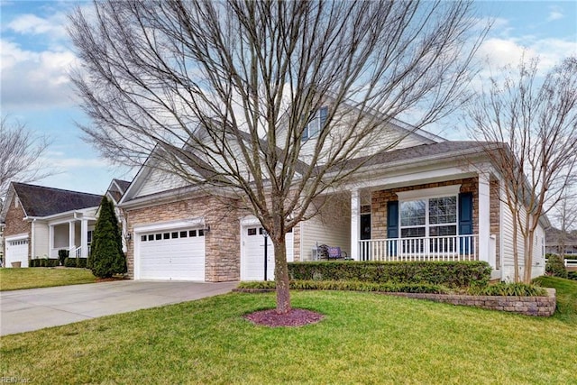 view of front of property with covered porch, stone siding, a front lawn, and concrete driveway