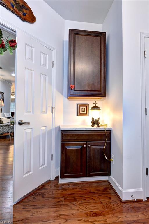 hallway with dark wood-style floors and baseboards