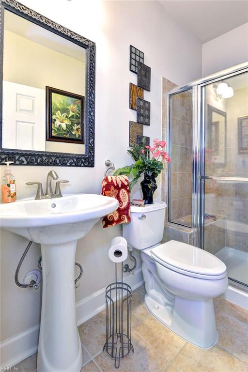 full bathroom with baseboards, a shower stall, toilet, and tile patterned floors