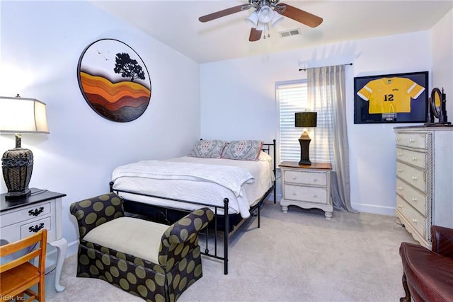 bedroom with baseboards, visible vents, a ceiling fan, and light colored carpet