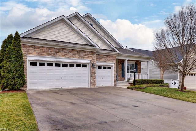 view of front facade with a garage, covered porch, stone siding, and concrete driveway