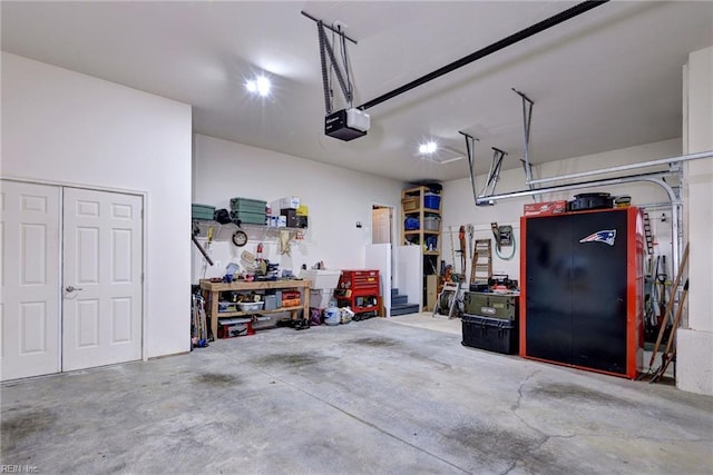 garage with a workshop area and a garage door opener