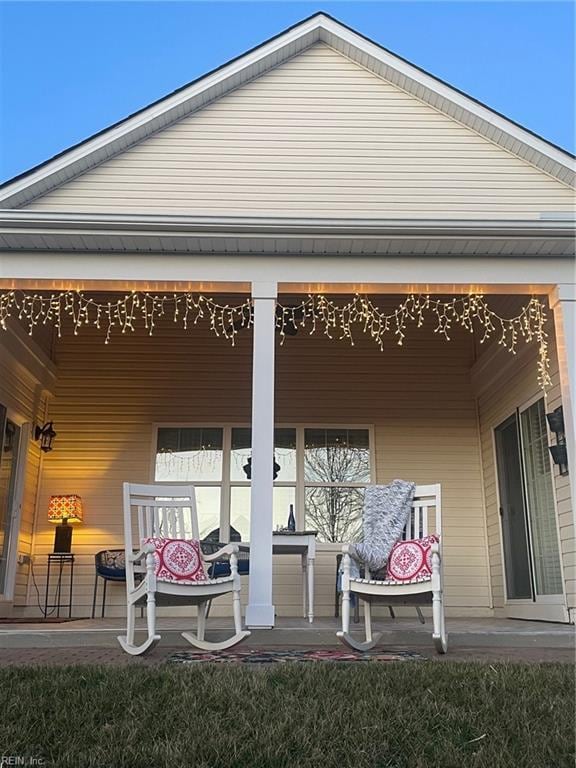 rear view of house featuring a porch