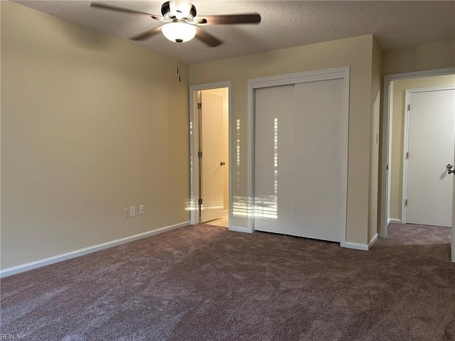 unfurnished bedroom featuring carpet, a closet, ceiling fan, a textured ceiling, and baseboards