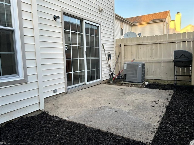 view of patio / terrace with grilling area, fence, and central air condition unit