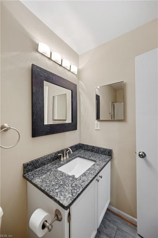 bathroom featuring baseboards and vanity