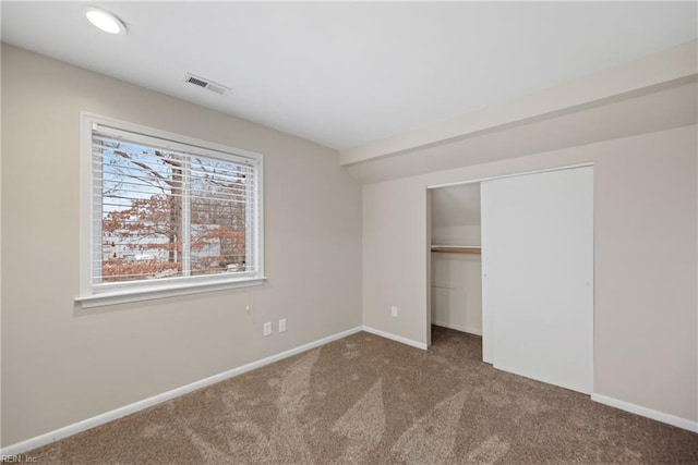 unfurnished bedroom with recessed lighting, a closet, visible vents, carpet flooring, and baseboards