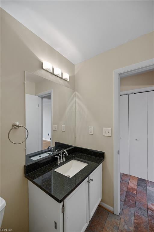 bathroom with baseboards and vanity