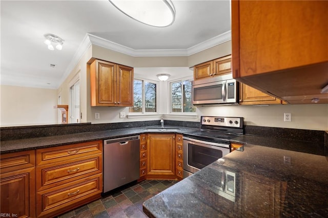 kitchen with stainless steel appliances, ornamental molding, brown cabinetry, and a sink