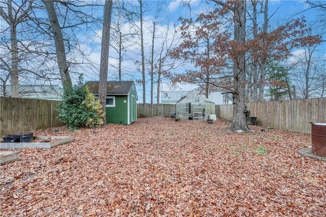 view of yard with an exterior structure, an outdoor structure, and a fenced backyard