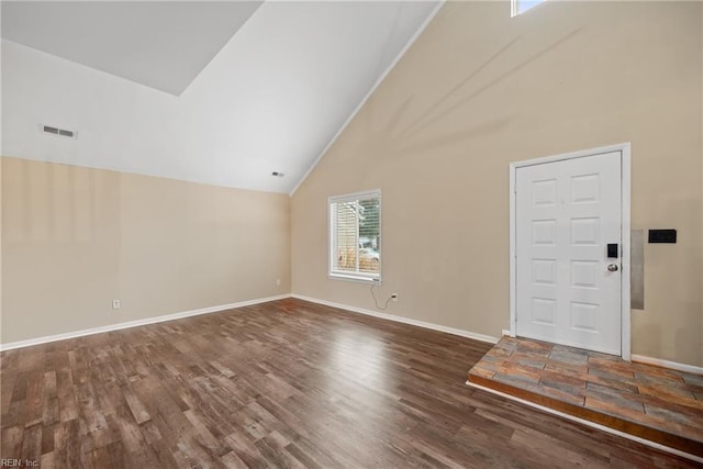 interior space with baseboards, visible vents, and wood finished floors