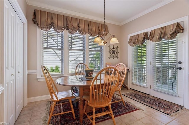 dining area featuring baseboards, ornamental molding, light tile patterned flooring, and a healthy amount of sunlight