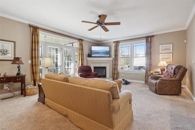 living room featuring light carpet, a fireplace, baseboards, and crown molding