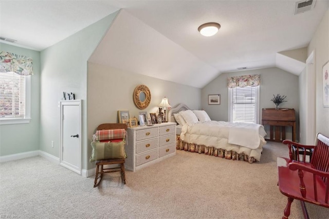 bedroom featuring lofted ceiling, visible vents, and carpet flooring