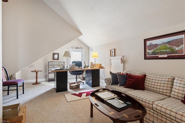 carpeted office featuring vaulted ceiling and baseboards