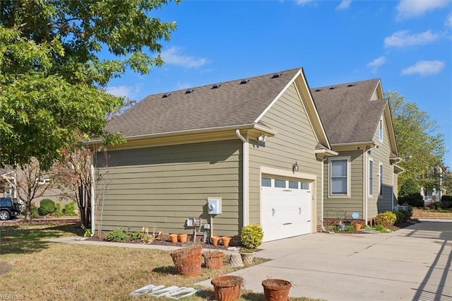 view of property exterior with a garage, concrete driveway, and a shingled roof