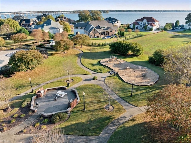 drone / aerial view with a water view and a residential view