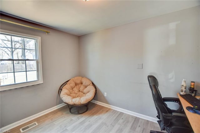 office featuring visible vents, baseboards, and wood finished floors