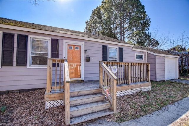 view of front of property featuring a garage and a deck