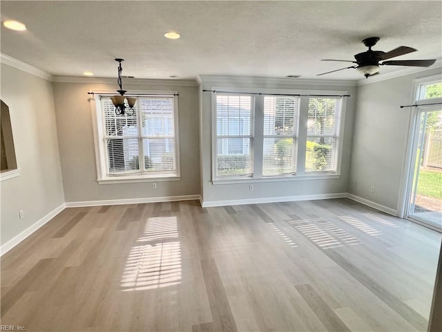 unfurnished dining area with baseboards, ornamental molding, and wood finished floors