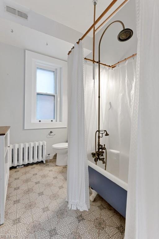 bathroom with radiator, shower / tub combo, visible vents, and toilet