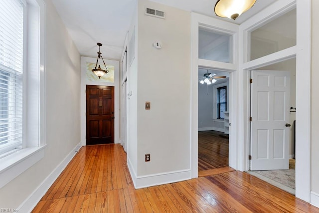 entrance foyer with light wood-type flooring, visible vents, and baseboards