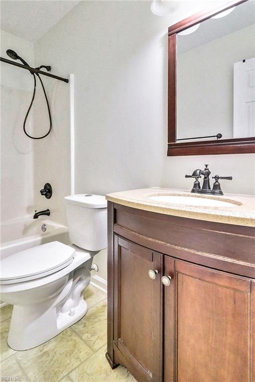 full bath featuring shower / bath combination, vanity, and toilet