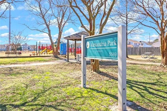 exterior space with a yard, playground community, and fence