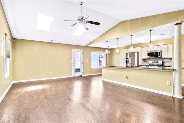 kitchen featuring decorative columns, white cabinets, dark wood-style floors, ceiling fan, and appliances with stainless steel finishes