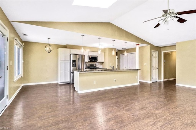 kitchen with dark wood finished floors, stainless steel appliances, white cabinetry, a sink, and ceiling fan with notable chandelier