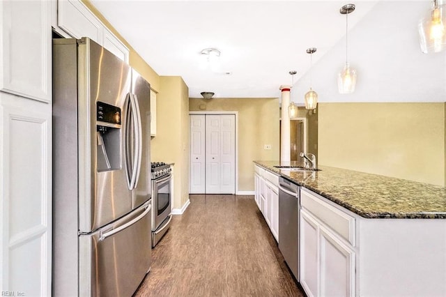 kitchen featuring dark wood-style floors, appliances with stainless steel finishes, white cabinets, and a sink