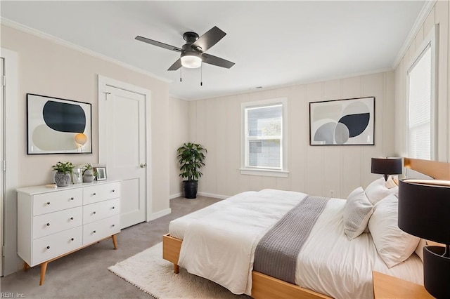 bedroom with a ceiling fan, light carpet, and crown molding