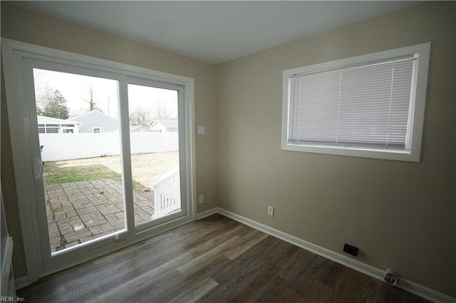 doorway to outside with dark wood-style flooring and baseboards